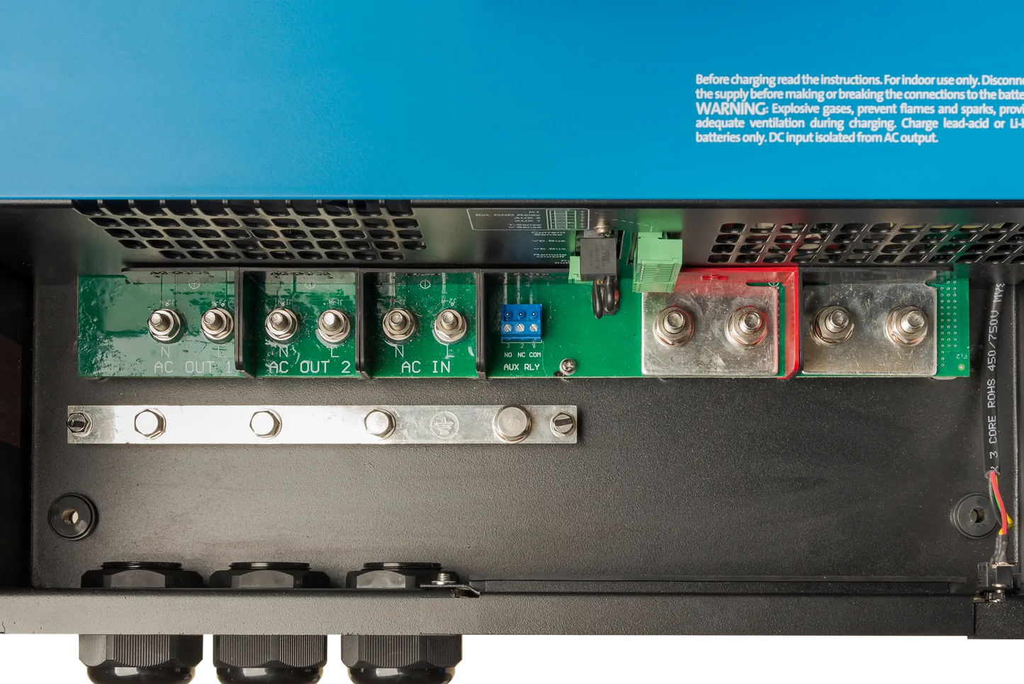 Close-up of electronic components on a power supply unit with blue background