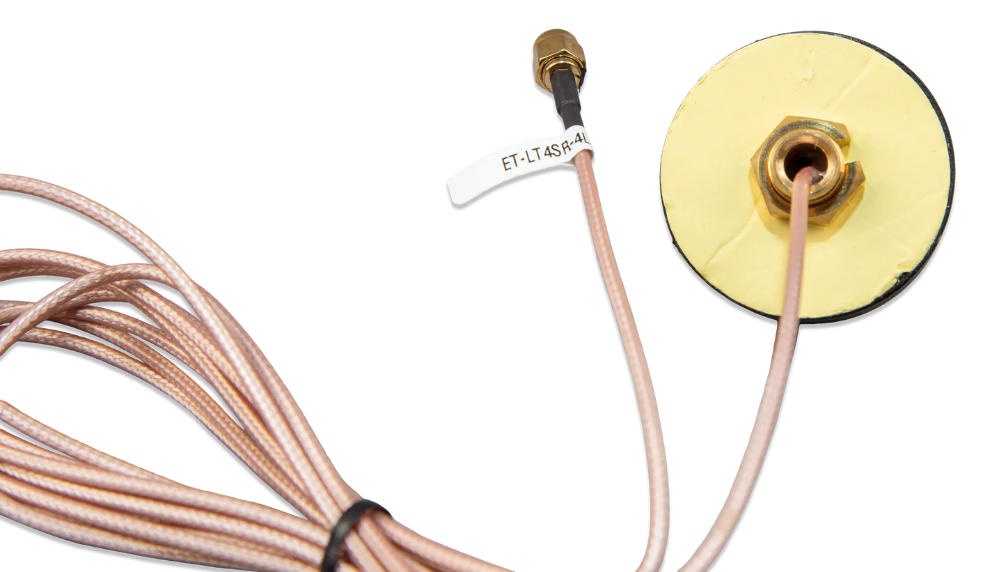 Gold-colored electronic component with cable on a white background