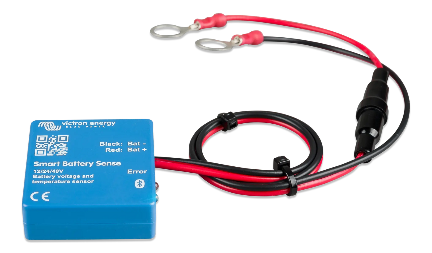 Blue battery monitor with red and black cables on a white background