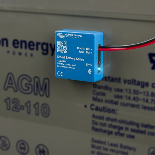 Blue smart battery sense sensor attached to a battery with visible branding.