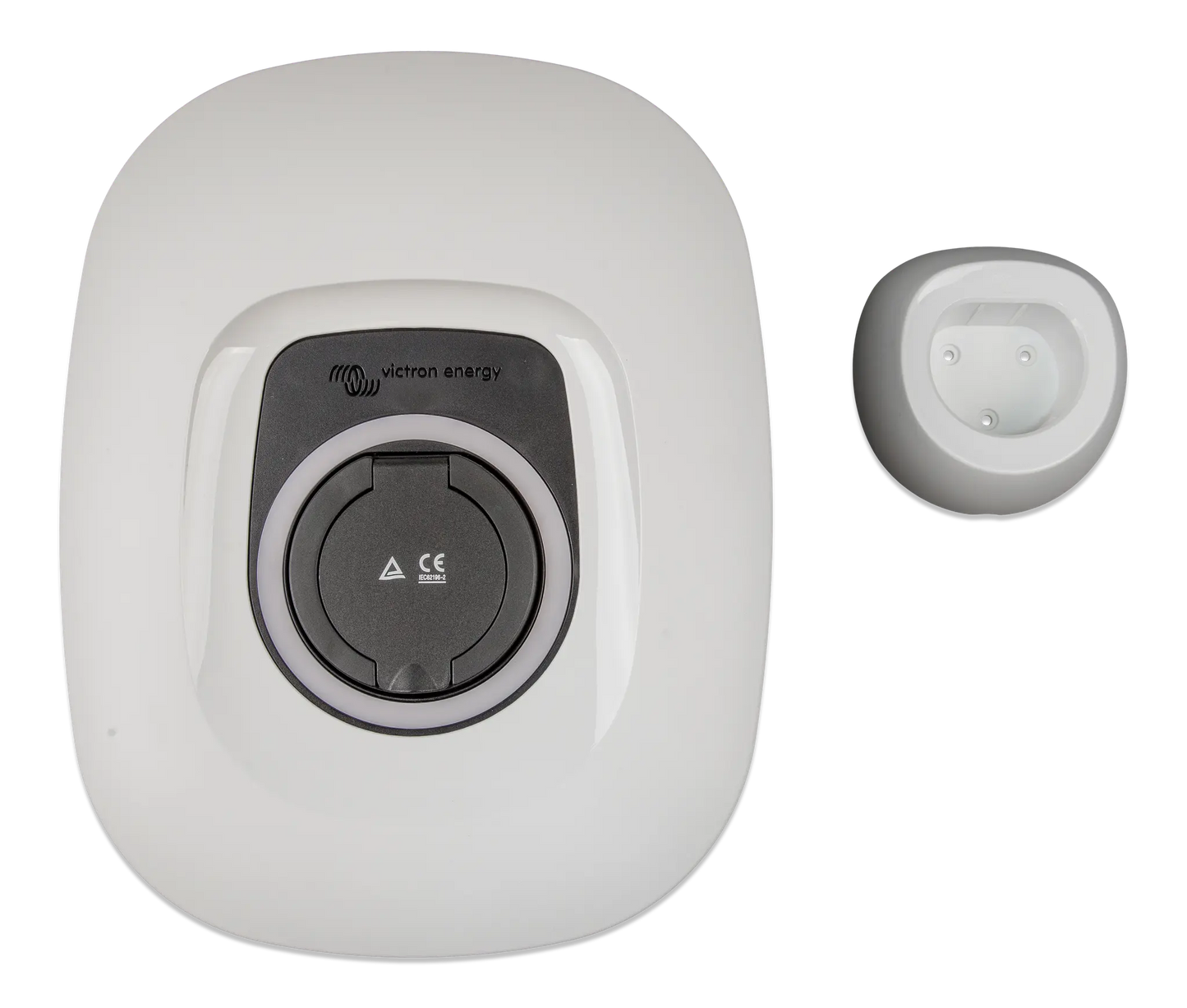 White electrical outlet with a small round device on a white background