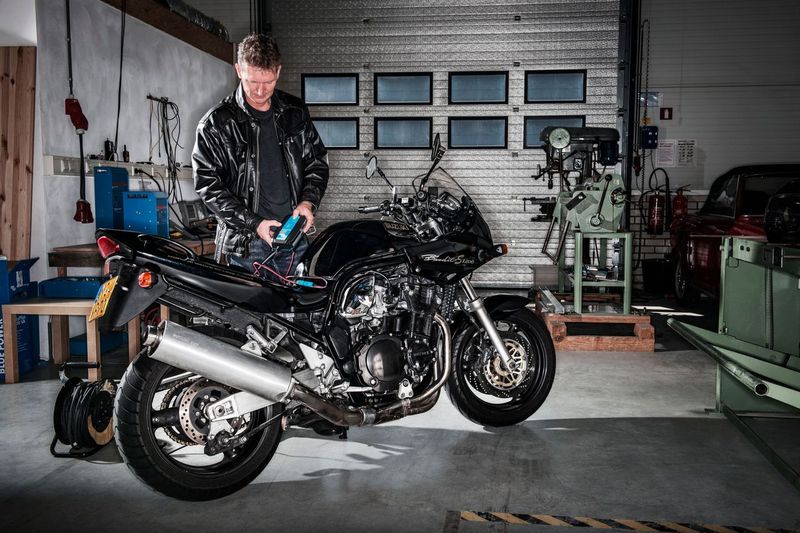 Man working on a motorcycle in a garage