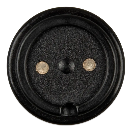 Black speaker driver with two metal washers on a white background