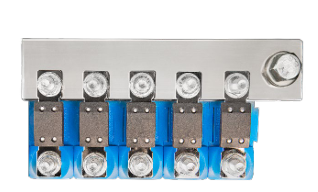 Metal terminal block with multiple connectors on a blue background
