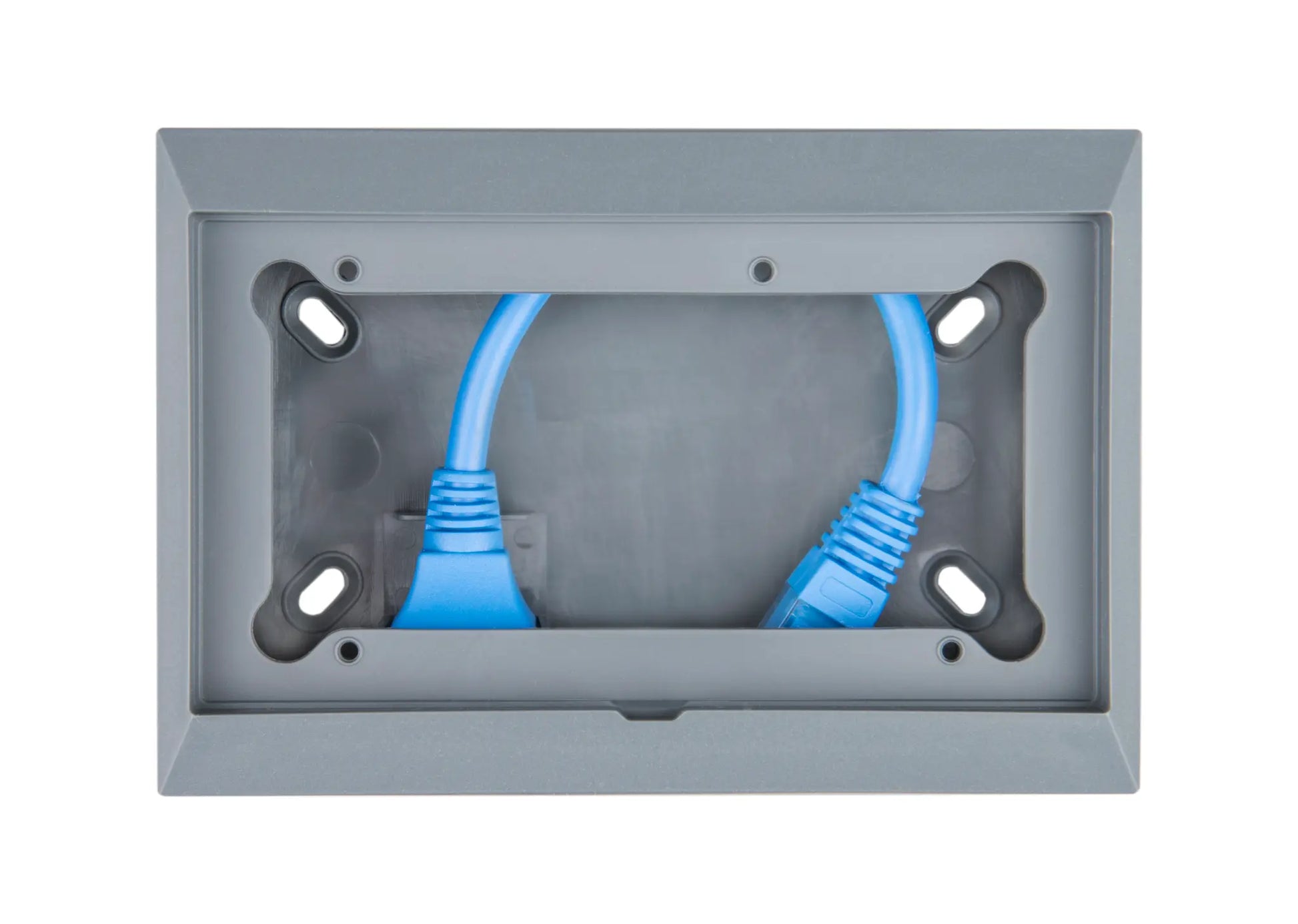 Gray wall plate with two blue Ethernet cables plugged into it on a white background