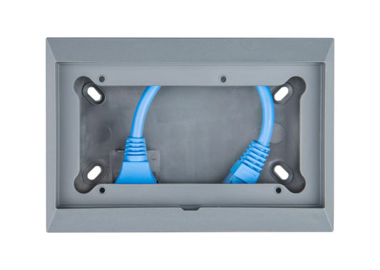 Gray wall plate with two blue Ethernet cables plugged into it on a white background